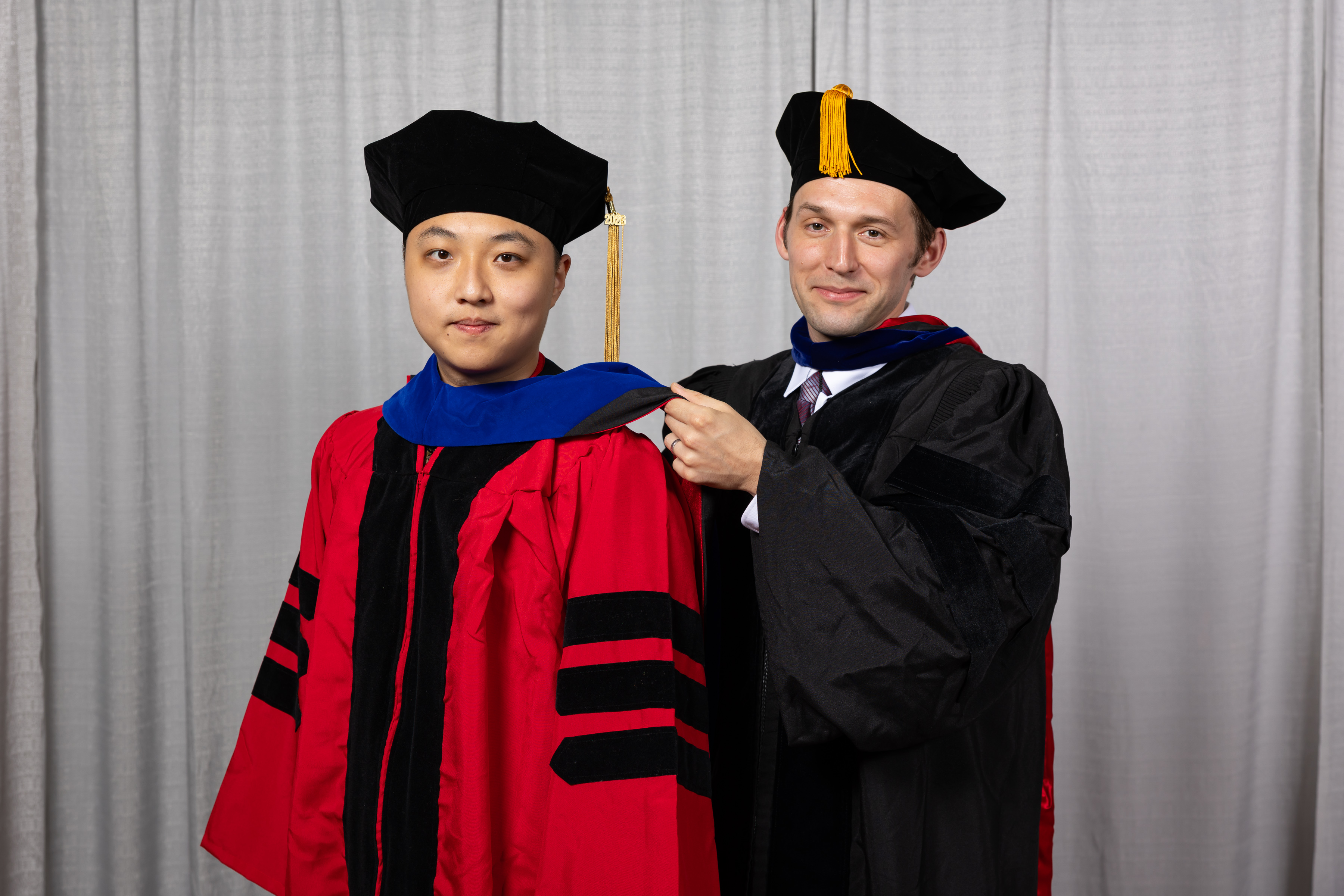 Alex Townsend hooding Annan Yu at graduation
